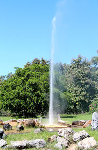 Scenic view of waterfall against sky