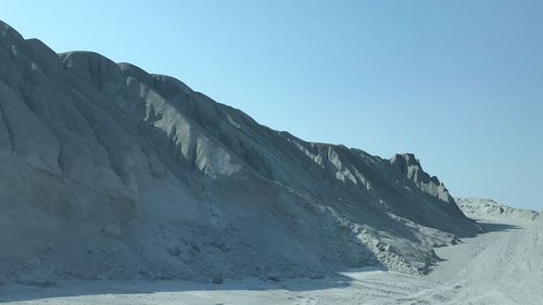 Scenic view of snowcapped mountains against clear blue sky