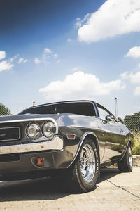 Close-up of vintage car against sky