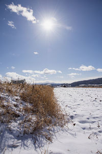 Scenic view of snow covered landscape against sky