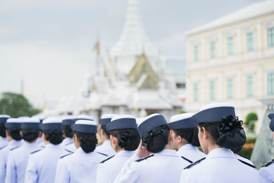 Rear view of women wearing uniform