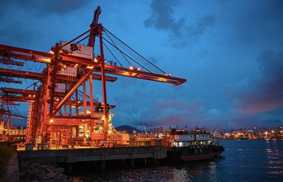 Commercial dock by pier against sky