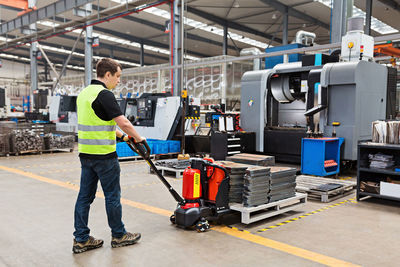 Rear view of man working in factory