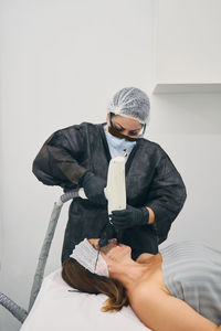 Rear view of a man holding umbrella