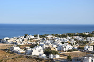 High angle view of townscape by sea against clear sky