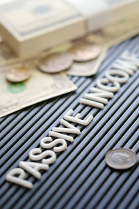 Close-up of text with money on table