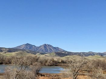 Scenic view of mountains against clear blue sky