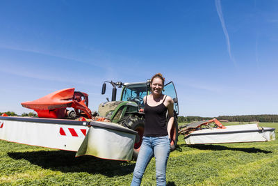 Woman standing in front of tractor