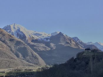 Scenic view of snowcapped mountains against clear blue sky