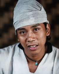 Close-up portrait of smiling young man wearing headscarf