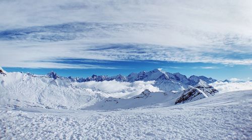 Scenic view of snowcapped mountains against sky