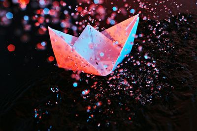 High angle view of paper boat and splashing water at pond