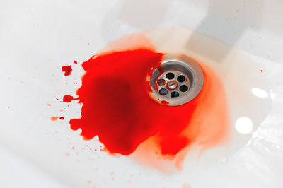 Blood in a white ceramic sink. bleeding gums or wound of a person. close-up of an abundance of blood