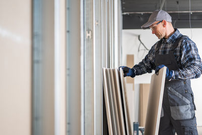 Side view of man working at construction site