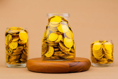 Close-up of coins in jars on table