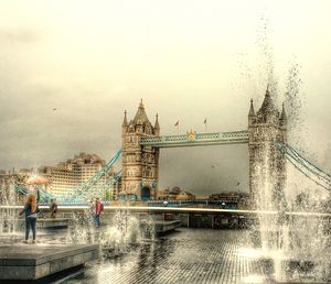 Bridge over river with city in background