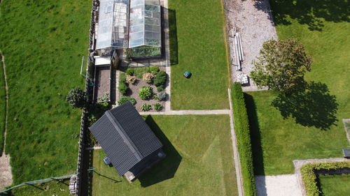 Aerial view of lawn by greenhouse