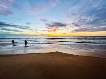 Scenic view of beach against sky during sunset