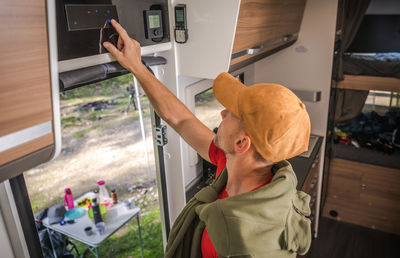 Rear view of man using mobile phone