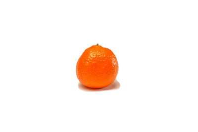 Close-up of orange fruit against white background