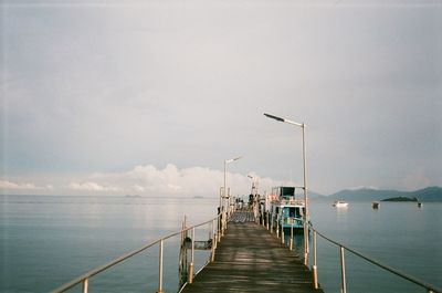Pier over sea against sky