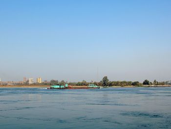 Scenic view of sea against clear blue sky