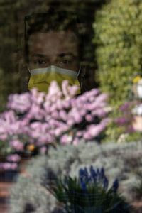 Portrait of woman on purple flowering plants