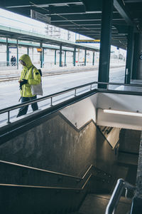 Low angle view of man walking on escalator