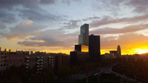 View of cityscape against cloudy sky during sunset