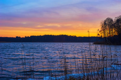 Scenic view of lake against sky during sunset