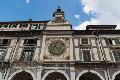 Low angle view of clock tower against sky