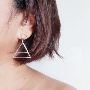 Close-up portrait of woman with hair against white background