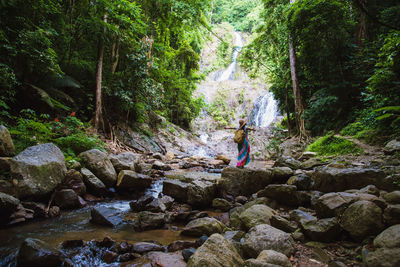 Woman standing on rocks in forest