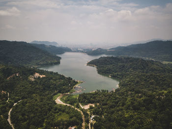 High angle view of river amidst mountains against sky