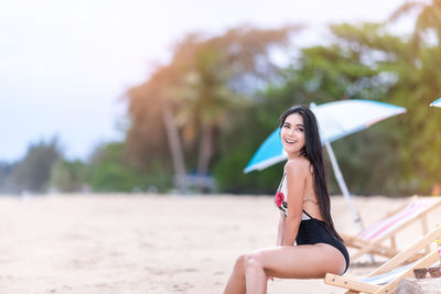 Young woman sitting on beach