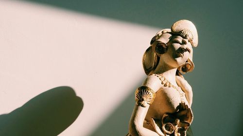 Close-up of angel statue against wall