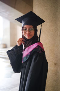 Portrait of woman wearing graduation gown