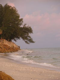 Scenic view of beach against sky during sunset