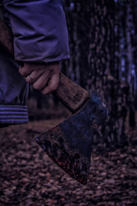 Close-up of hand on wood