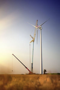 Crane installing wind turbine