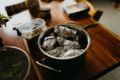 High angle view of baked potatoes in foil on table