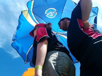 Low angle view of people against sky