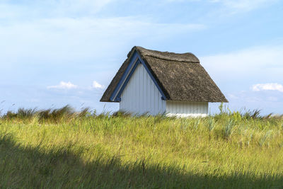 House on field against sky