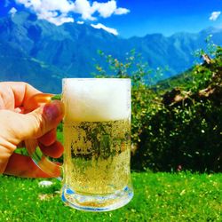 Cropped hand holding beer glass