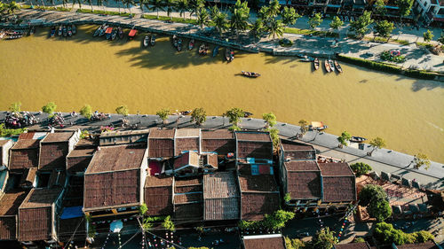 High angle view of river amidst trees in city