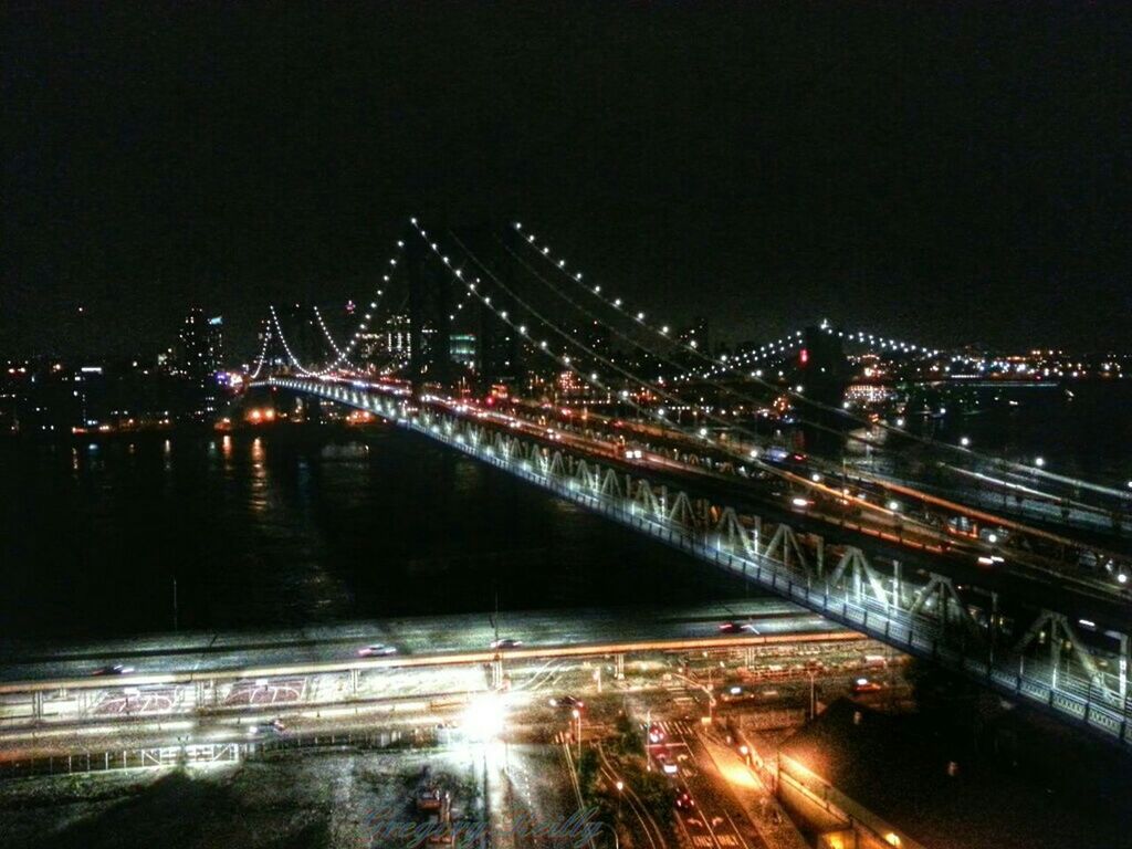 illuminated, night, bridge - man made structure, architecture, built structure, connection, city, transportation, long exposure, river, light trail, street light, engineering, building exterior, bridge, suspension bridge, city life, road, sky, water