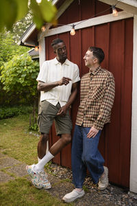 Full length of young woman using mobile phone