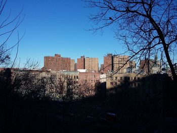 Buildings in city against clear sky