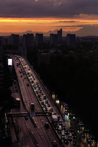 High angle view of illuminated cars on bridge in city