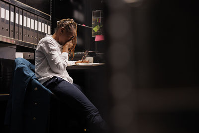 Side view of woman using mobile phone